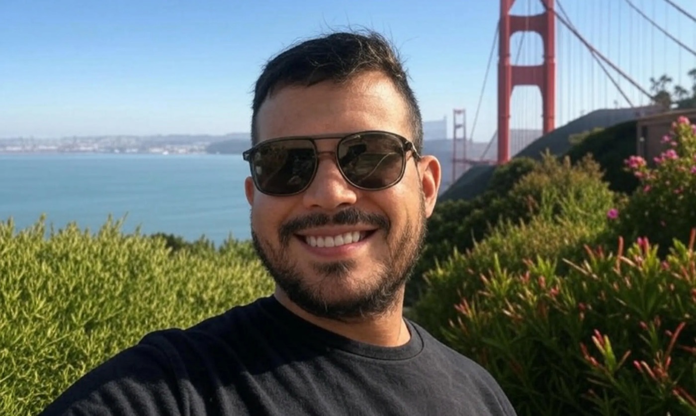 Tony, owner of n-frames, smiling outdoors near the Golden Gate Bridge
